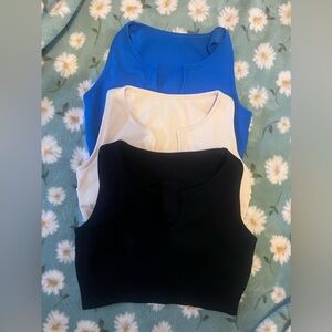 Set of 3 Athletic Tops/ Sports Bras. One blue, one black, one cream. NWOT.